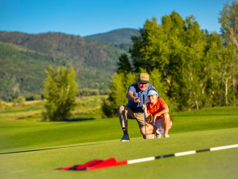 Man and girl putting